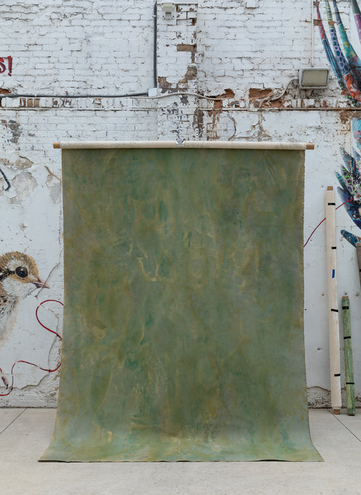 Green hand painted backdrop on a wall in a city