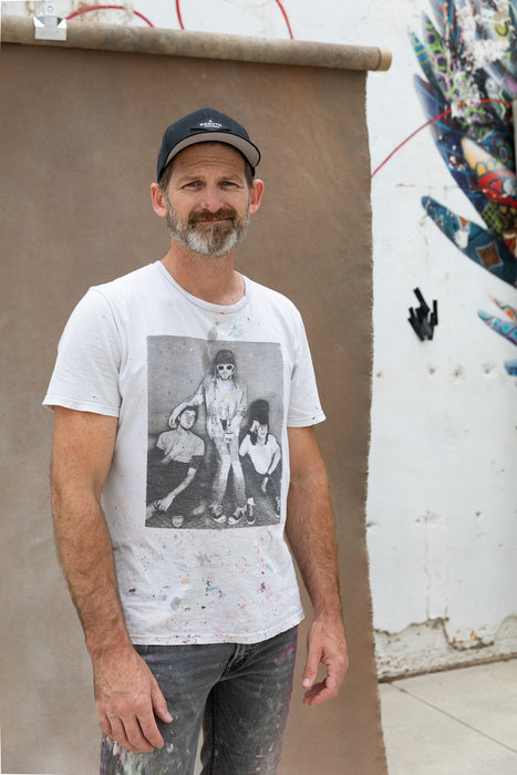 Matthew Peterson of Ultraviolet Backdrops wears a painted Nirvana shirt with his hand painted backdrop