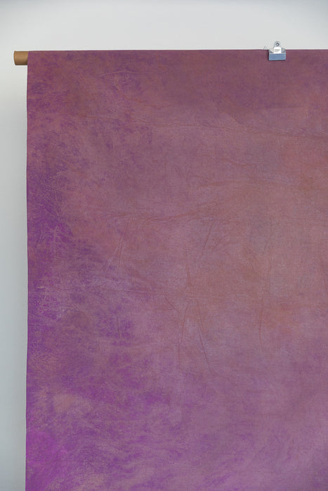 an 8x10 backdrop hangs on a c-stand in a photo studio.