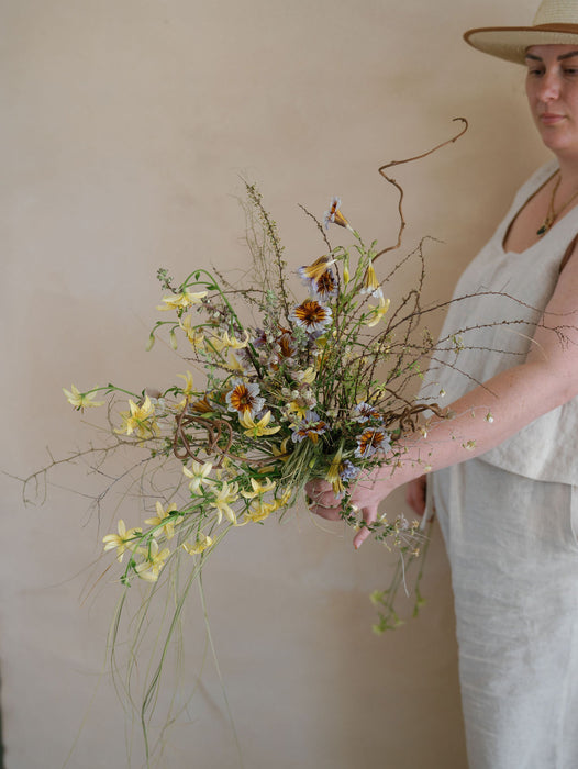Subtle creamy warm tones in the Great Salt Lake canvas backdrop by Ultraviolet Backdrops with Nicole Chapman holding a bouquet. Image by Anya Kernes.