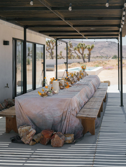 Nicole Chapman Ultraviolet Tablescape shows textured backdrop with Utah stones, poppies. Photo by Anya Kernes