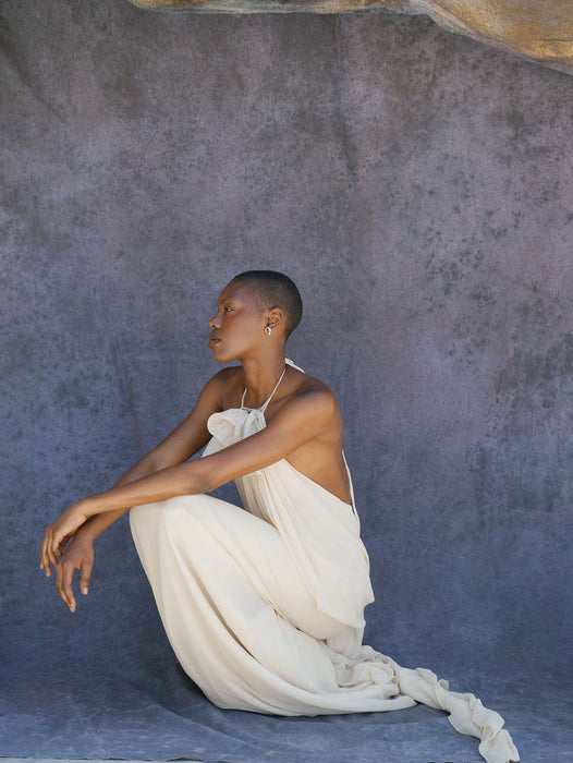 high end model poses in couture gown with purple backdrop. Image by Anya Kernes