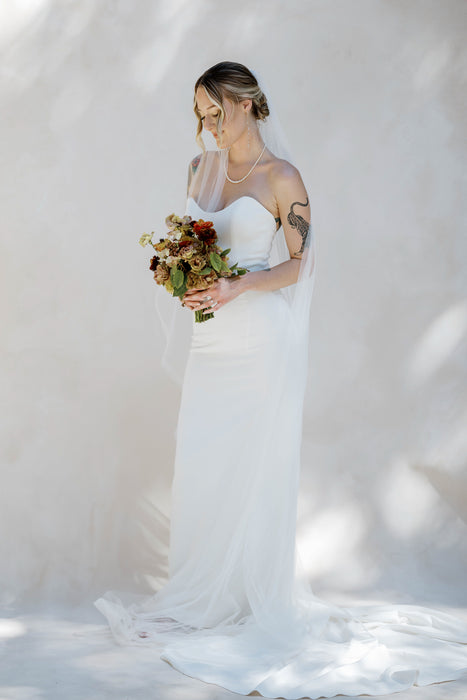 Brandi Crockett photographs bride on subtle white hand painted backdrop.