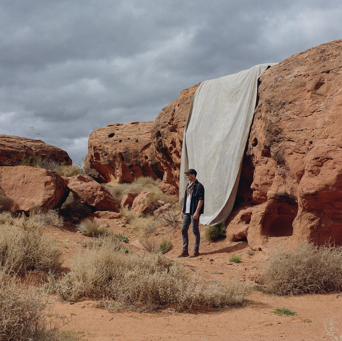 huge muslin Ultraviolet backdrop red rocks with man standing with backdrop
