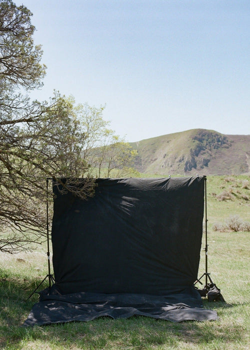 Huge, durable, muslin backdrop clipped to a traditional backdrop stand in the hills above Salt Lake City.