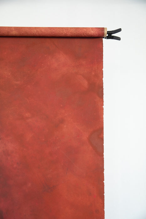 red canvas backdrop on a long cardboard role