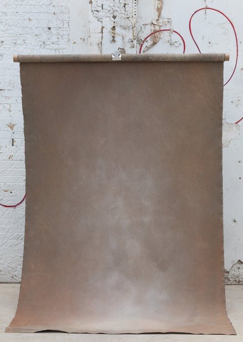 Warm brown backdrop hung on a backdrop stand