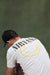 Man in Nirvana tee hunches to straighten hand painted backdrop