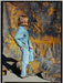 Person wearing a denim outfit standing against a textured, multicolored backdrop