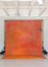 Orange and red textured backdrop in a studio setting