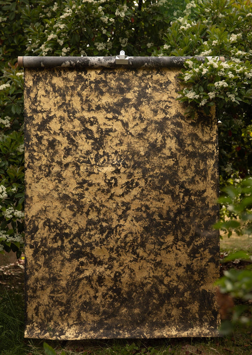 gold and black backdrop surrounded by spring flowers