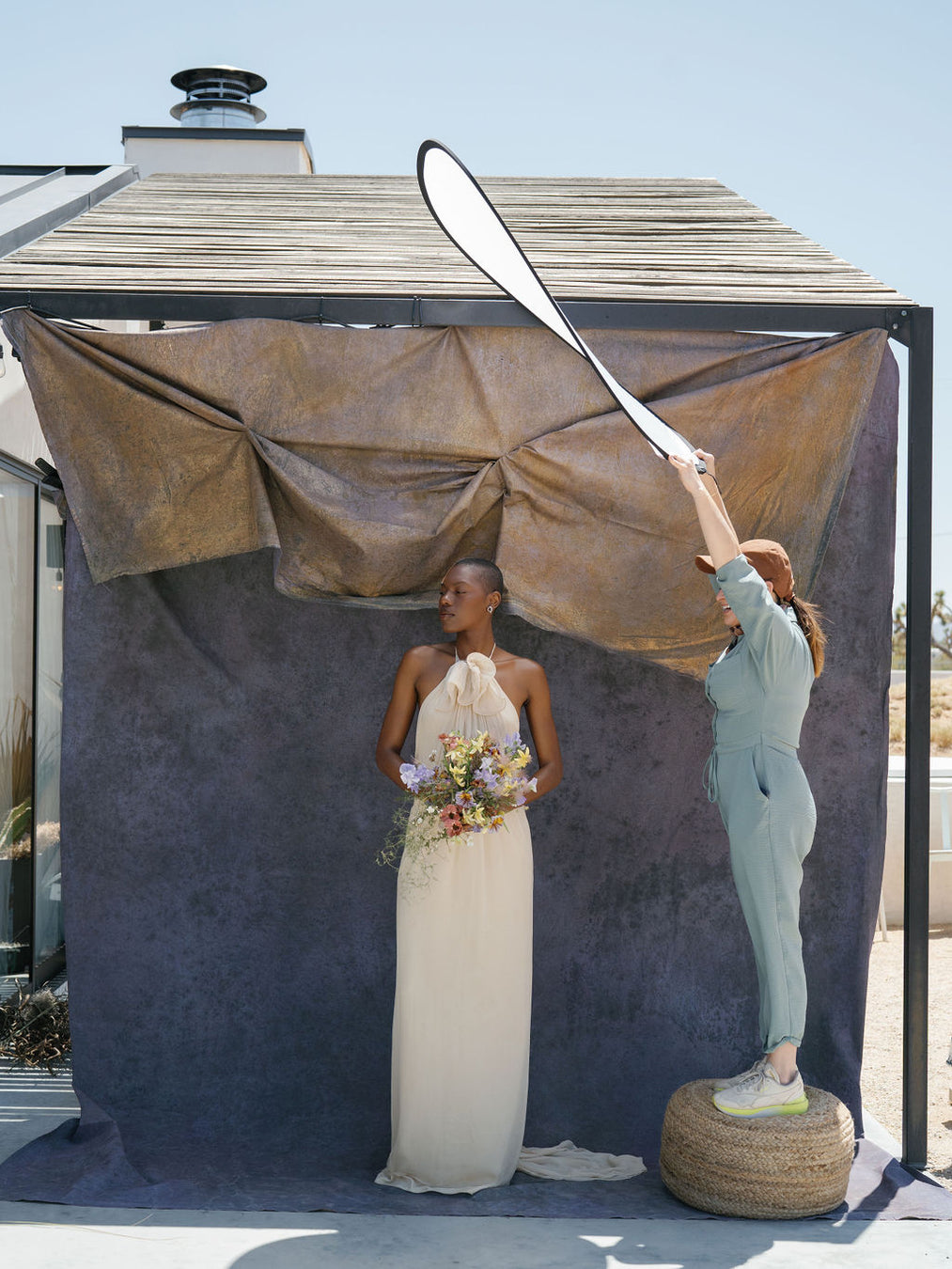 Custom hand painted gold and purple backdrop with model and photographer's assistant. Image by Anya Kernes