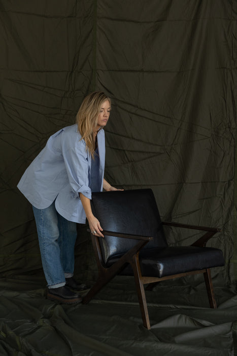 stylist sets leather chair on giant rentable parachute backdrop