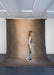 woman walks on huge muslin backdrop by ultraviolet