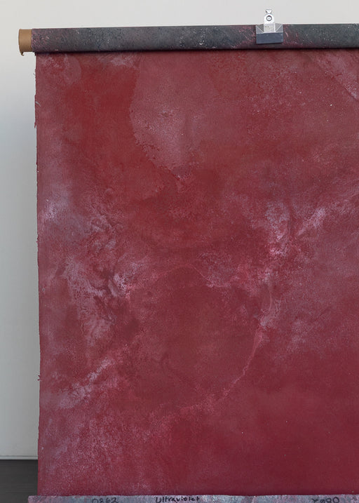 red textured painting on canvas by Ultraviolet Backdrops hung with a vice clamp and c-stand.
