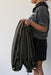 Person holding a green parachute backdrop against a white background