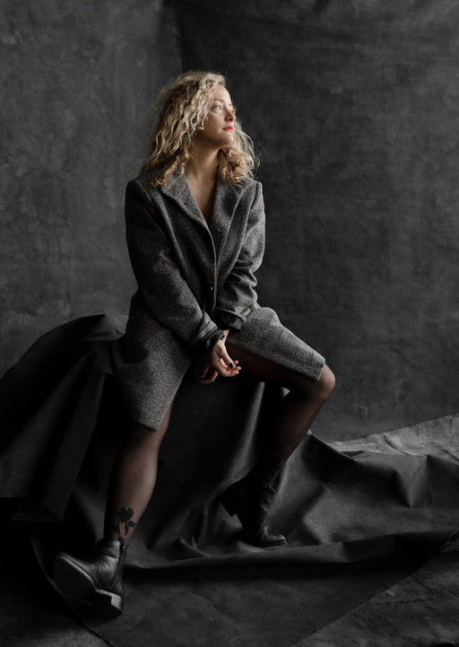 Vintage Black backdrop by Ultraviolet layered with blonde woman sitting on covered apple boxes. Image by Steph Kirk.
